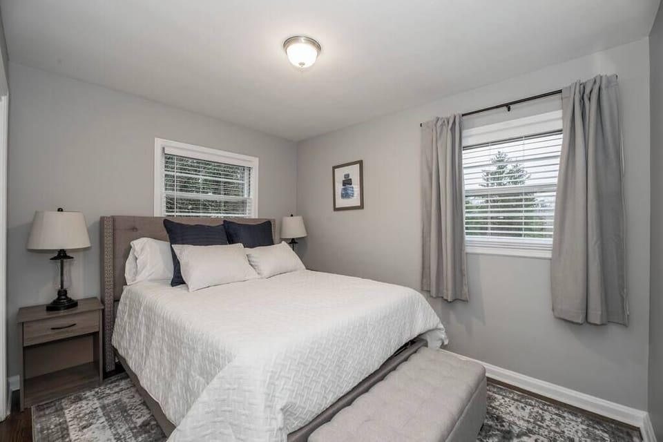 This first floor bedroom features a comfortable king bed and simple, welcoming décor, a relaxing space designed for rest and a pleasant stay.