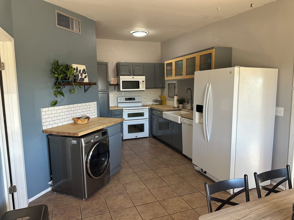 Kitchen with double oven, full sized fridge, microwave, dishwasher 