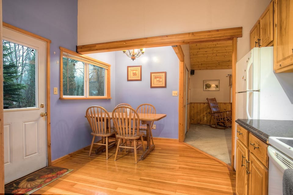 Convenient door to the deck with grill and hot tub, looking into the living room beyond