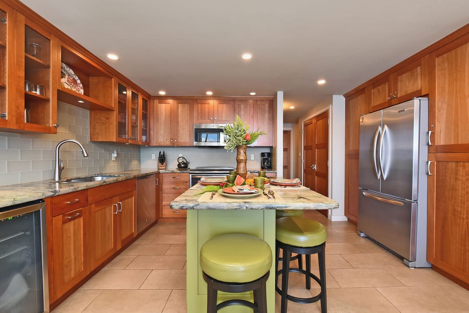 Warm, Welcoming Kitchen
A spacious kitchen with rich wood cabinetry, stainless‑steel appliances, and a cheerful island made for gathering.