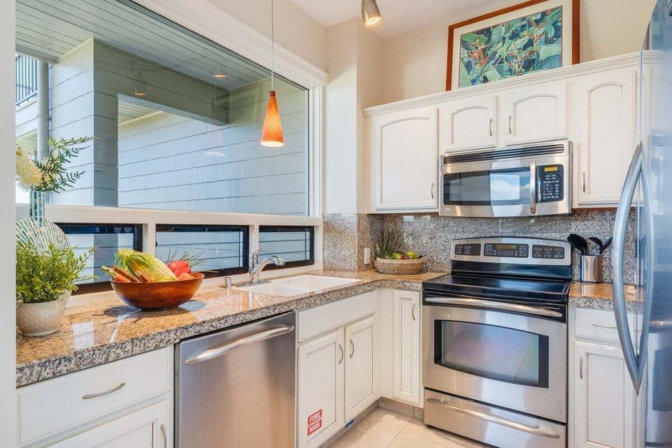 Cook with ease in a modern kitchen featuring stainless steel appliances and granite counters.