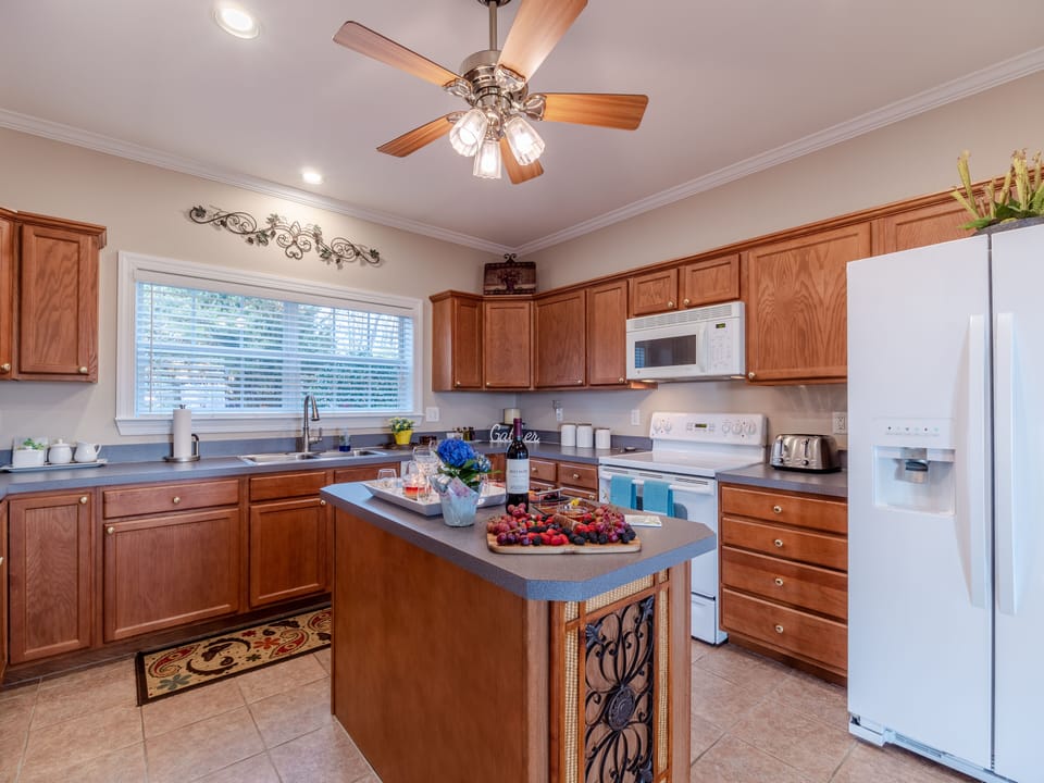Functional, well stocked kitchen with island for entertaining