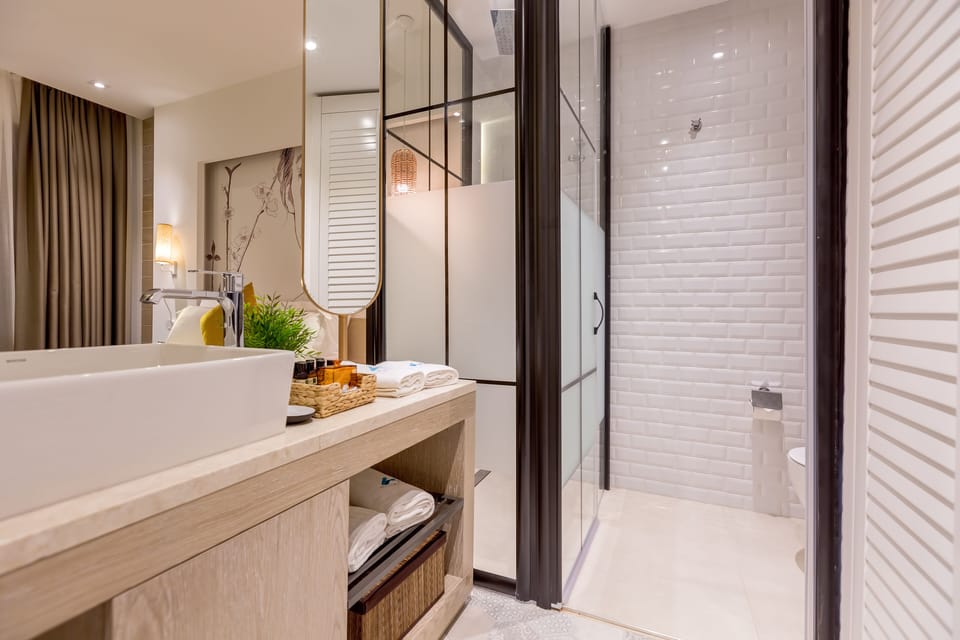Shower, designer toiletries, hair dryer, bathrobes