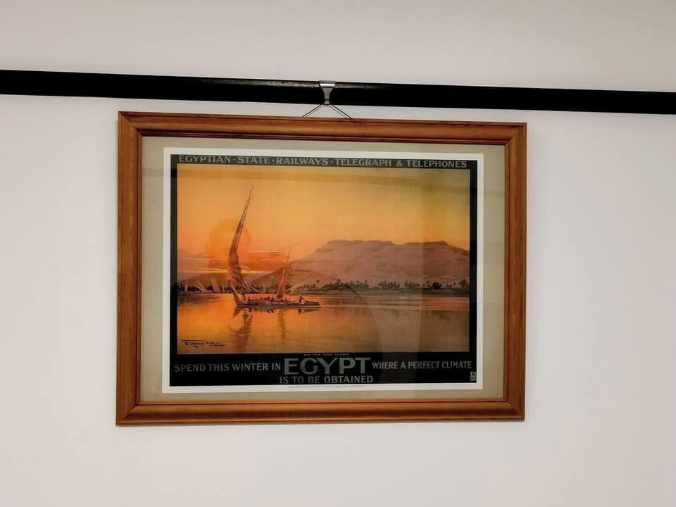 Artful Retreat: Vintage Egyptian poster enhances charm, captivating views of distant shores await!