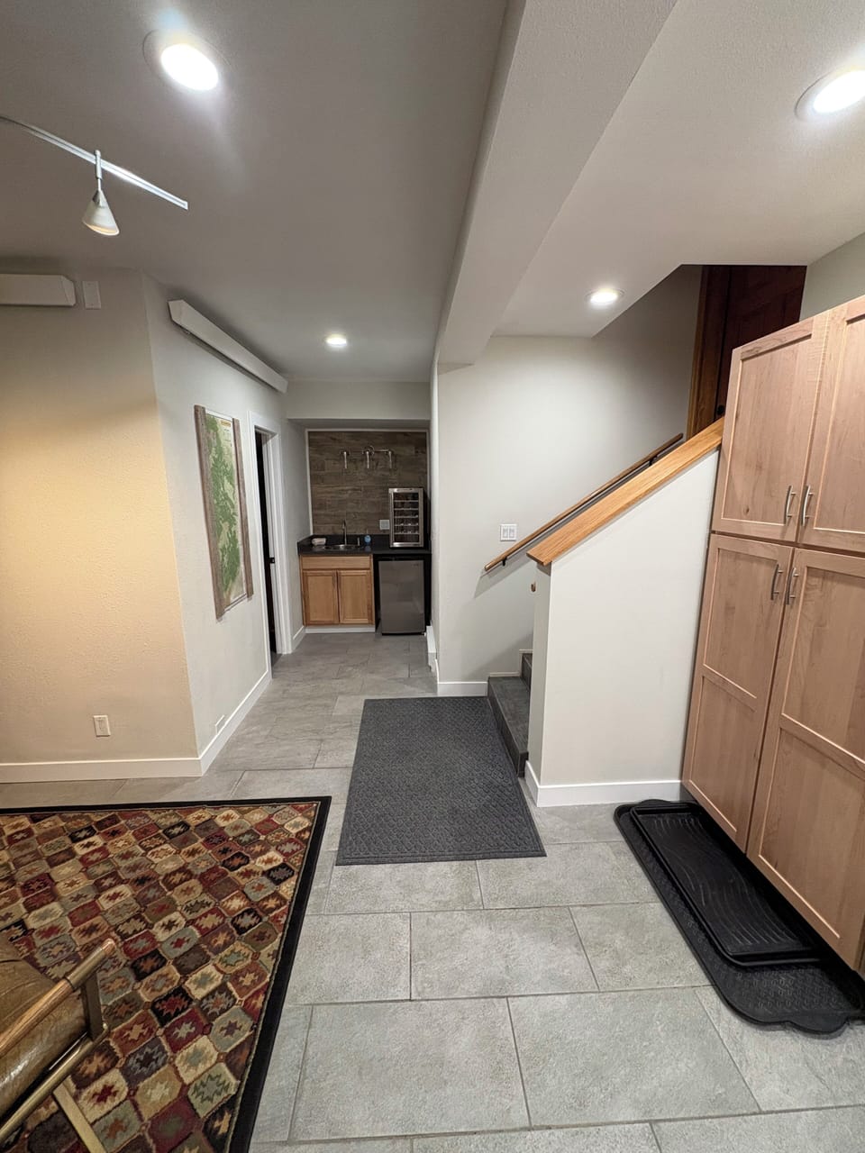 Downstairs with additional sink, wine cooler, and small fridge 