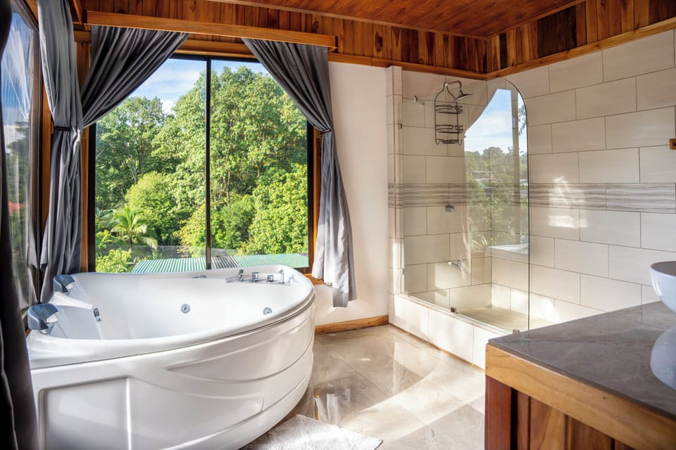 Deluxe Quadruple Room, Hot Tub | Bathroom | Shower, hair dryer, towels, toilet paper