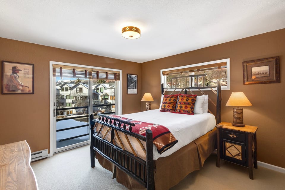 The primary bedroom is furnished with a cozy queen bed, flat screen TV, Juliette balcony and plenty of space for your belongings.