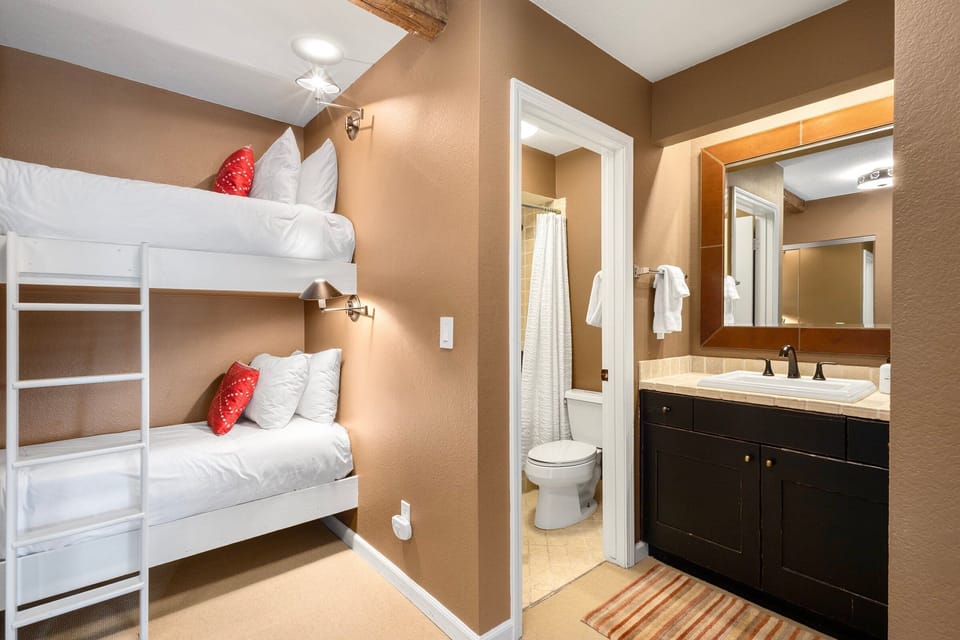 The bunk area is cozy and ideal for extra guests or little ones, with each bunk featuring its own light and closet space for belongings.