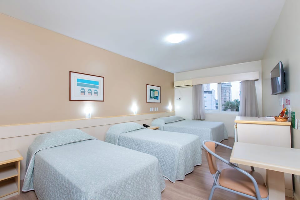 Standard Quadruple Room | Minibar, in-room safe, desk, blackout drapes