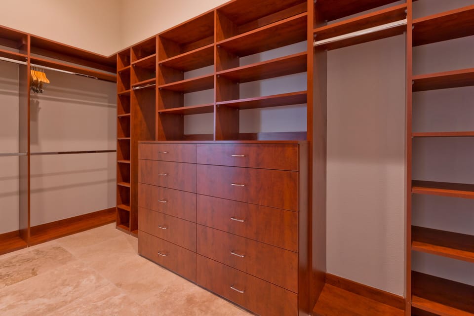 Walk-in closet with two entrances in the master bedroom.