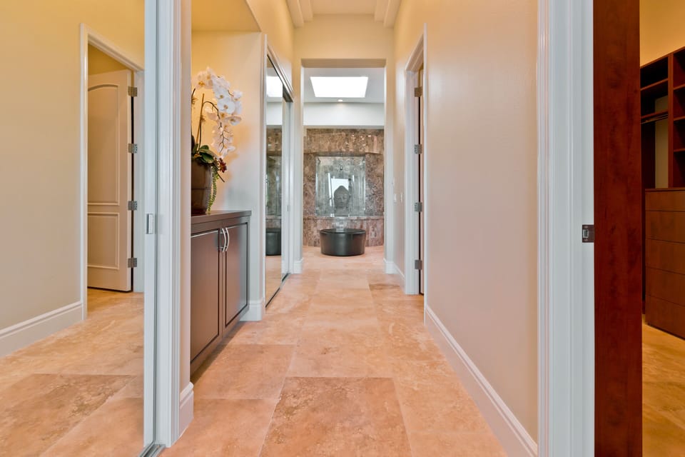 Large hallway in master with two closets on the left and a walk-in closet.