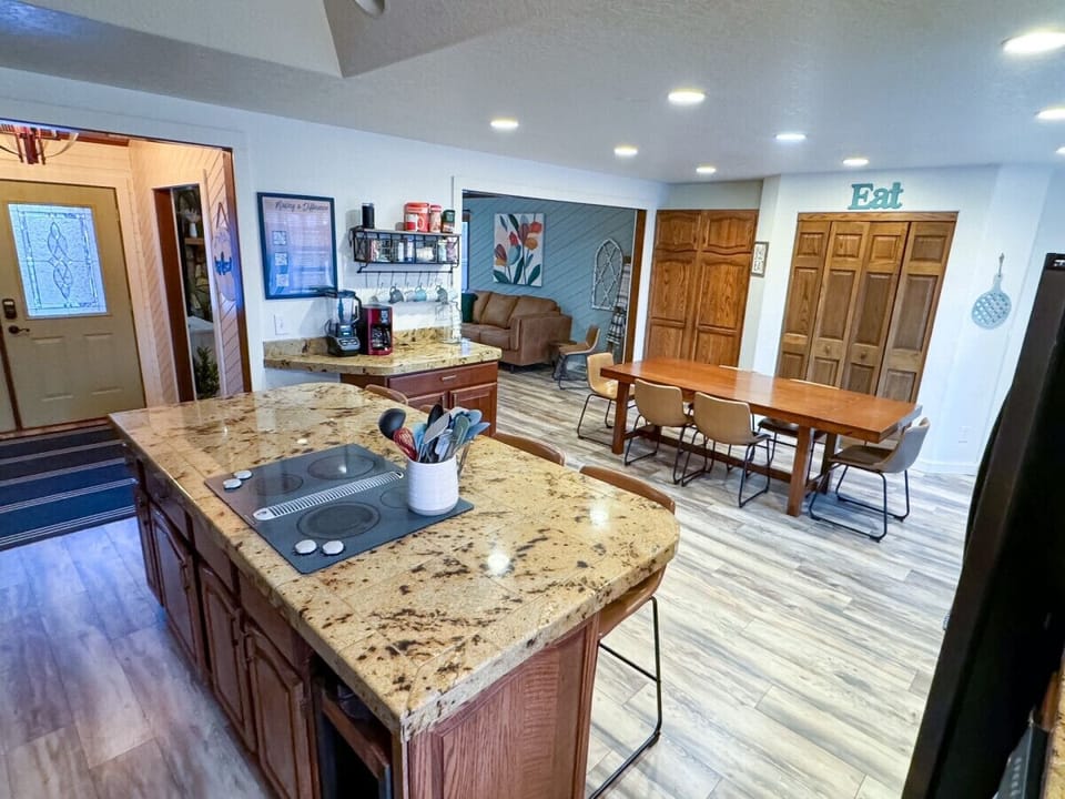 Large kitchen island for additional seating, open to dining room and living room with access to the backyard.
