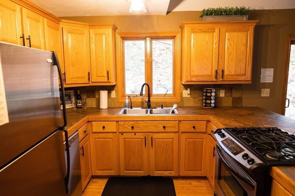 Fully stocked kitchen with loaded spice rack.