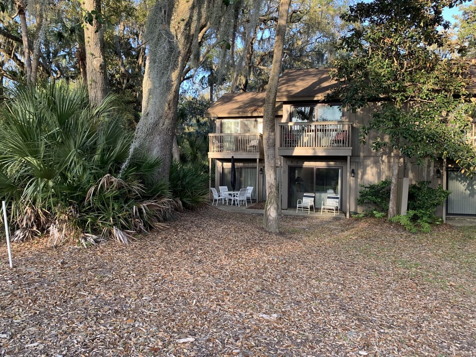 Rear elevation. Patio behind family area. Two balconies one off of each bedroom