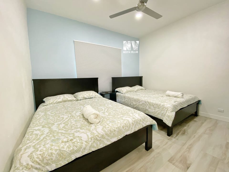 Another guest bedroom with 2 queen size beds.