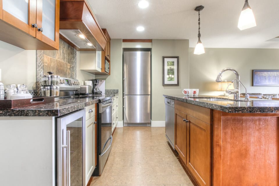Fully Stocked Kitchen features Gorgeous Granite Counters & Stainless Appliances 