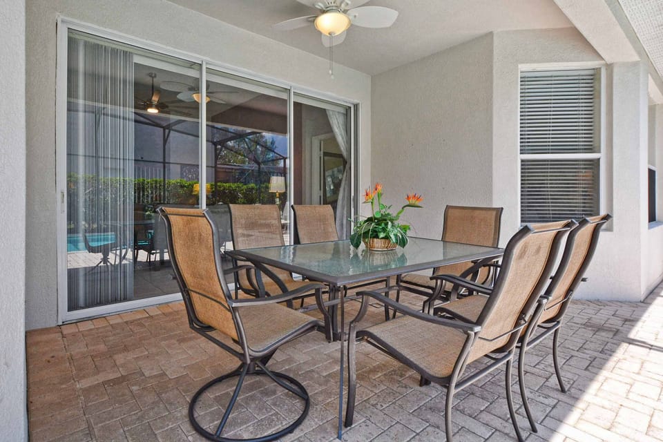 Lanai features a ceiling fan for keeping cool on hot summer days (note this patio set has been replaced with a circular table that seats 4).