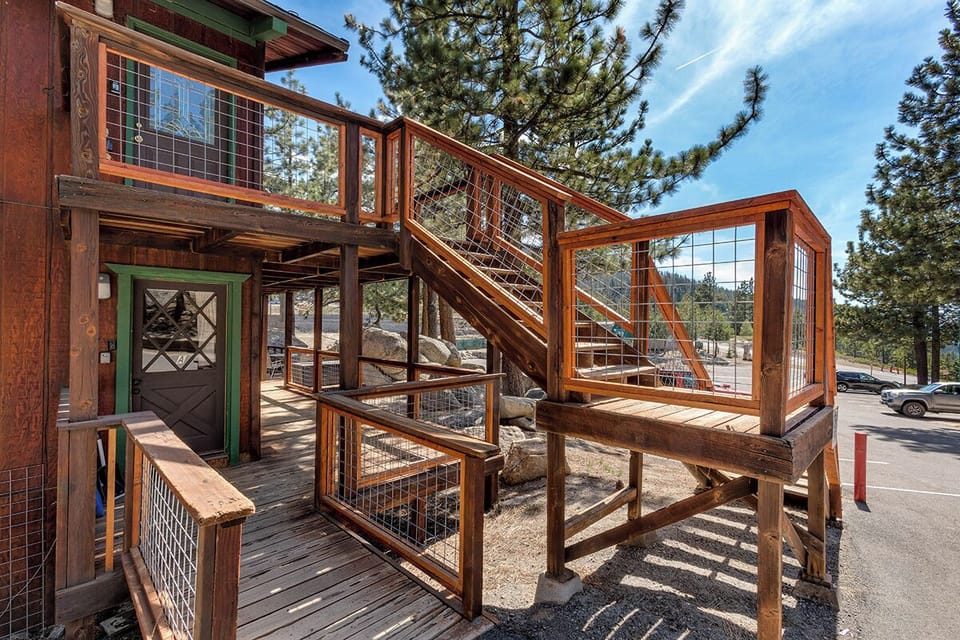 A beautifully crafted wooden staircase leading up to your mountain escape.