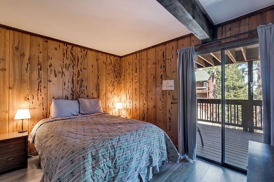 A comfortable bedroom with a queen bed and direct balcony access.