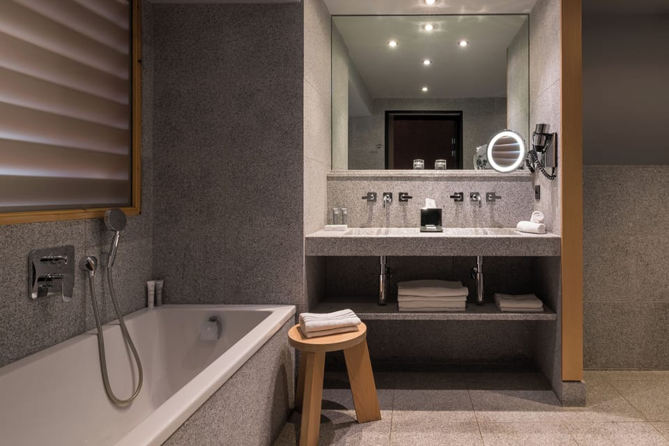 Separate tub and shower, designer toiletries, hair dryer, bathrobes