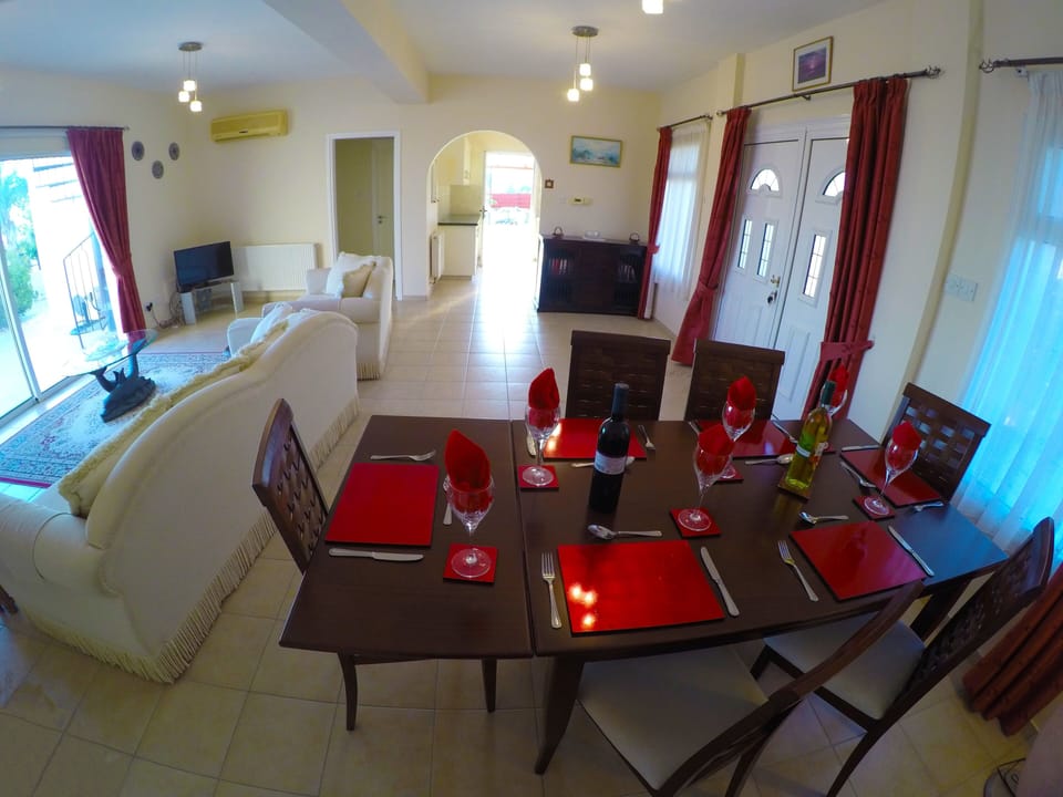 inside dining and lounge leading to kitchen and pool