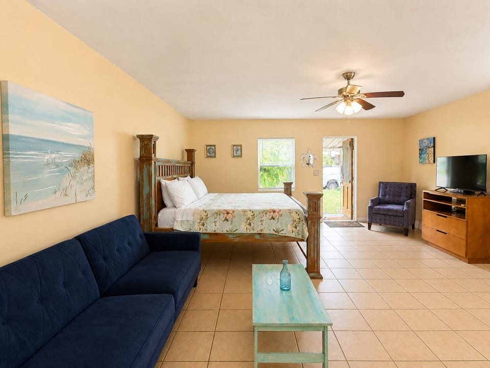 Coastal studio with cozy bed, TV & a couch that folds flat for extra sleeping.