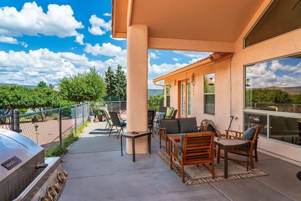 An outdoor dining table and BBQ grill for entertaining family and friends