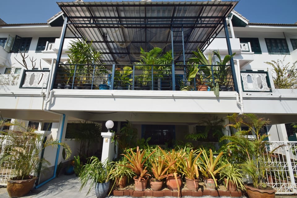 exterior view of the house showing the garden at entrance and front balcony.