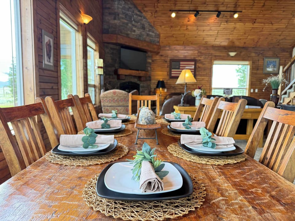 The dining room has a large table with seating and additional seating at the bar of the Island in the kitchen.