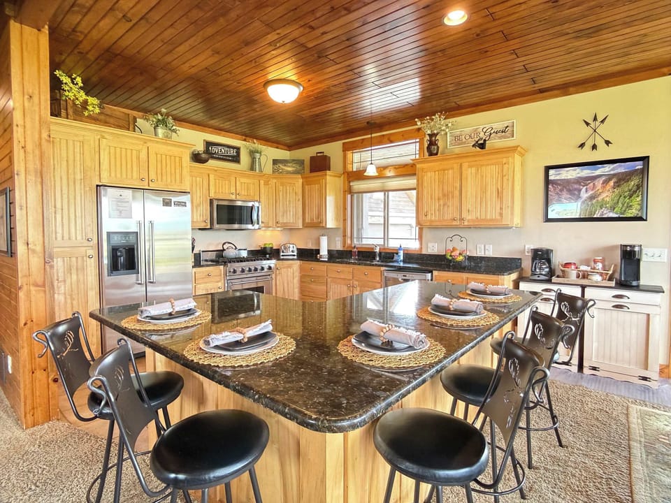 Cook and chat together around the expansive kitchen island. This fully equipped space features gorgeous granite countertops and counter seating.