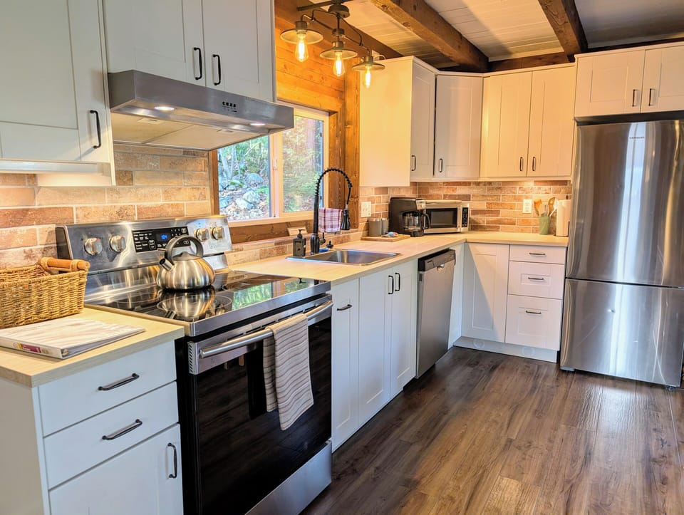 Fully stocked kitchen with modern appliances.
