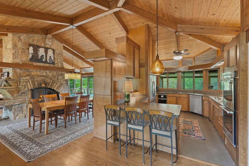 Chef's kitchen w/ figured veneer cabinetry,  artisan pendant, double-oven.