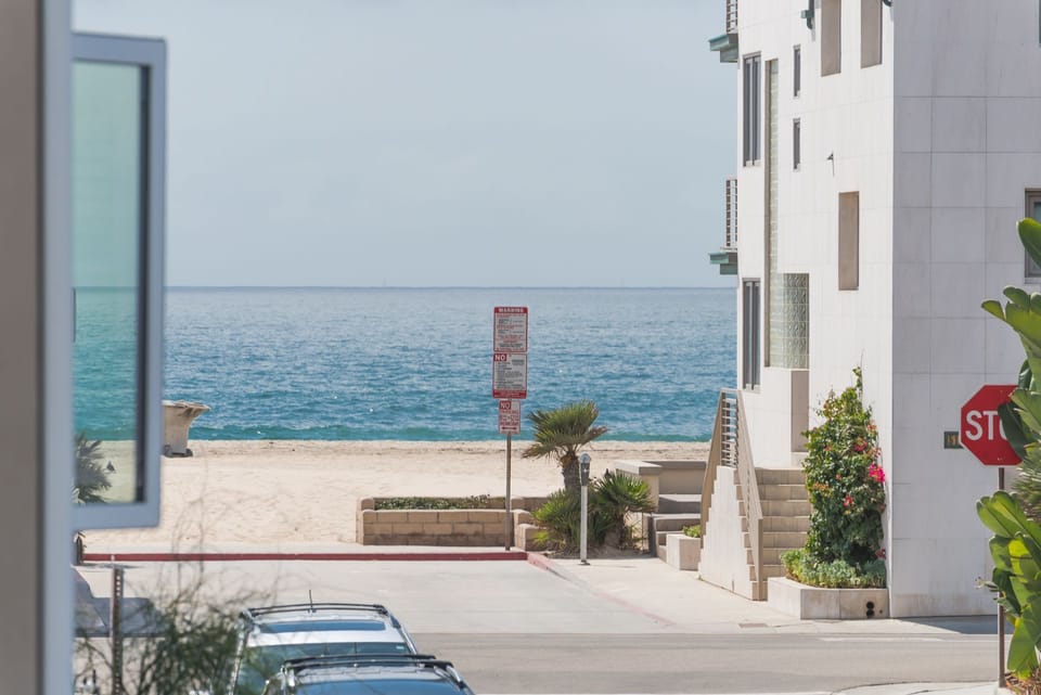 The beach is just three homes away from your front door.
                