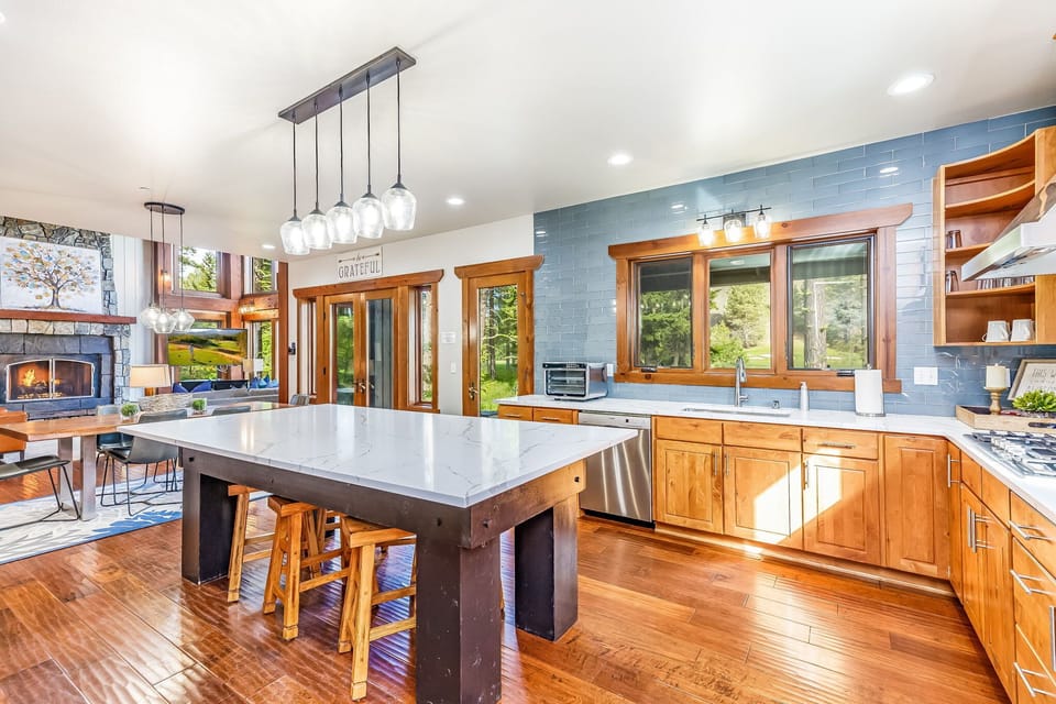 Grand Fitted Kitchen with High End Appliances and Glass Top Bar Table and Polished Dining Table