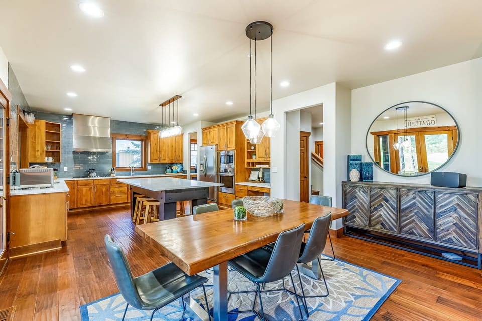 Grand Fitted Kitchen with High End Appliances and Glass Top Bar Table and Polished Dining Table