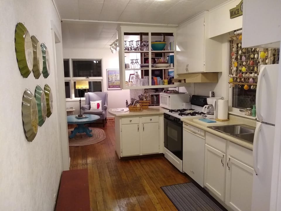 Modern kitchen appliances include refrigerator, dishwasher, range, & microwave.