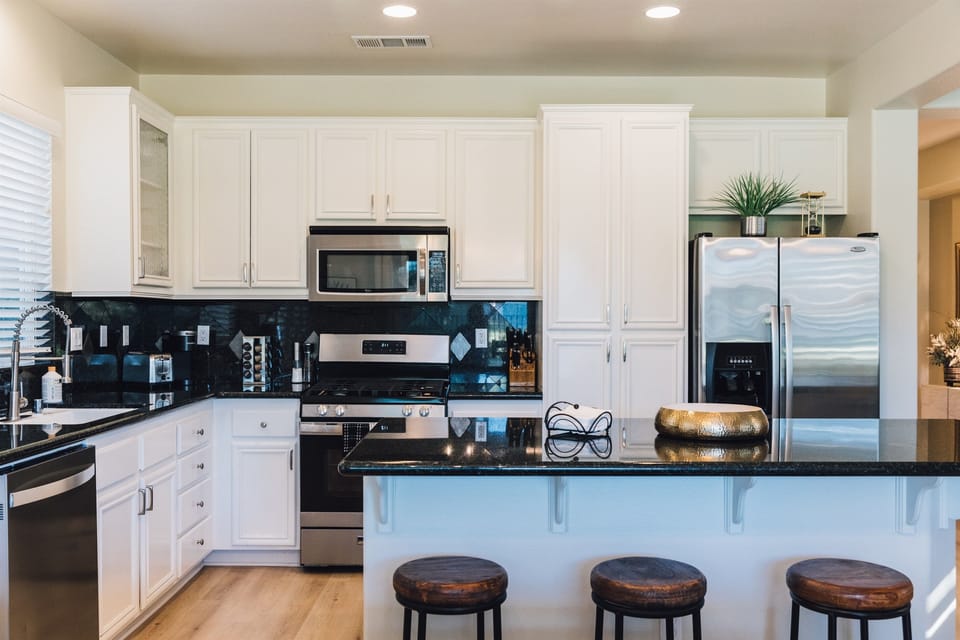 Step into a culinary haven where the kitchen is fully equipped for all your gourmet adventures. Open to a cozy living area and stunning views of the golf course—perfect for relaxing and entertaining.