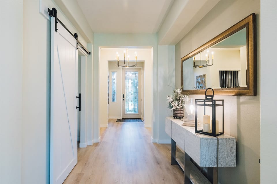 Looking back down the hall toward the front door, with three of the bedrooms just ahead.