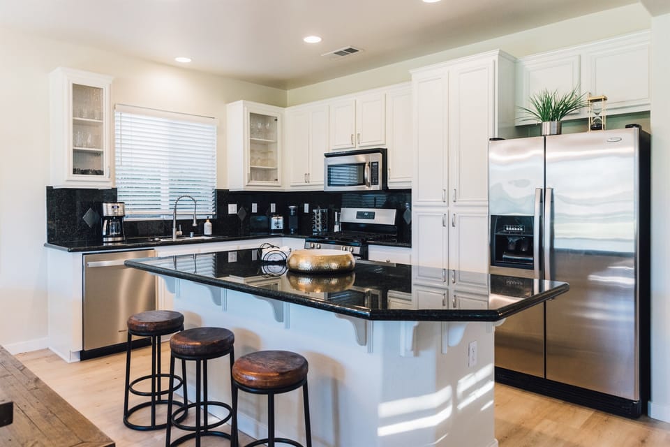 Step into a culinary haven where the kitchen is fully equipped for all your gourmet adventures. Open to a cozy living area and stunning views of the golf course—perfect for relaxing and entertaining.