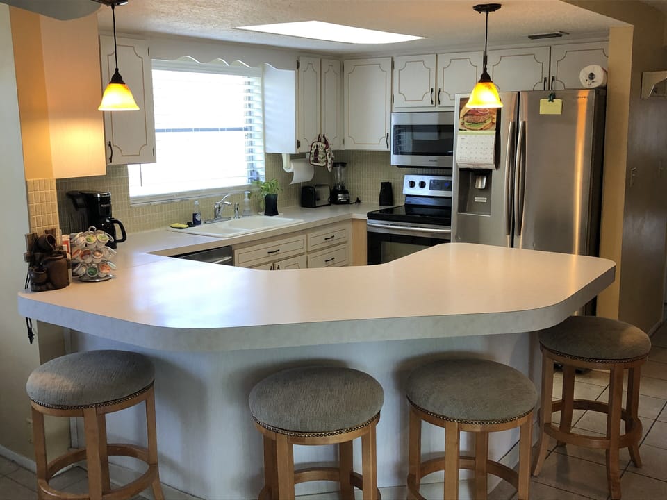 Full size Kitchen with stove, microwave, refrigerator, and dishwasher.