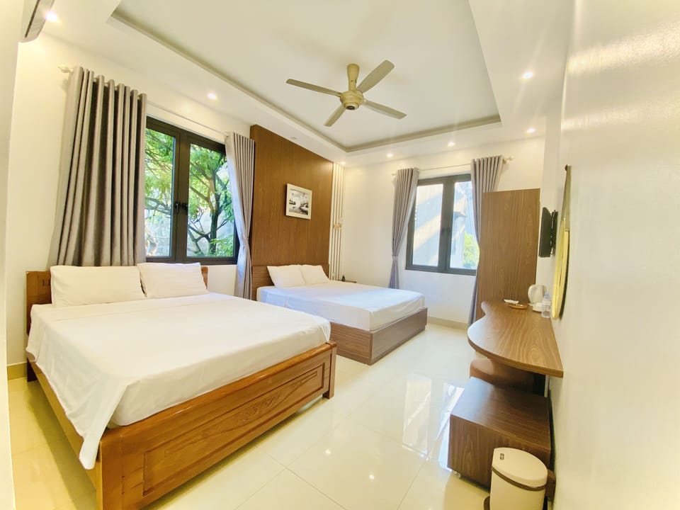 Superior Quadruple Room | Minibar, in-room safe, desk, laptop workspace