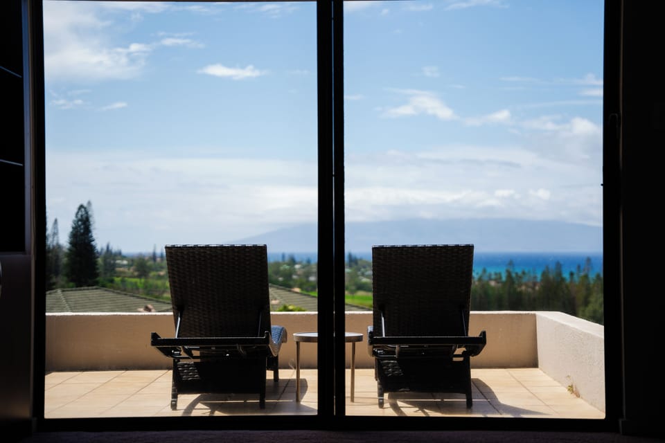 Pool and grounds - Resort pool with lounge chairs surrounded by tropical landscaping.