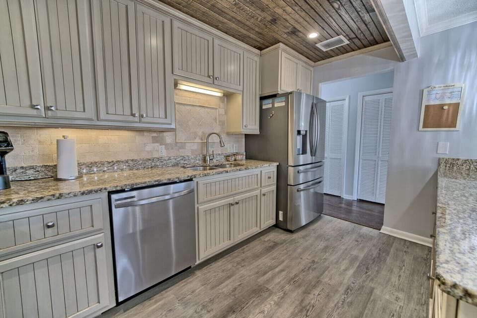 Prepare meals in this elegant kitchen with granite counters and pendant lighting, all while enjoying the stunning ocean backdrop