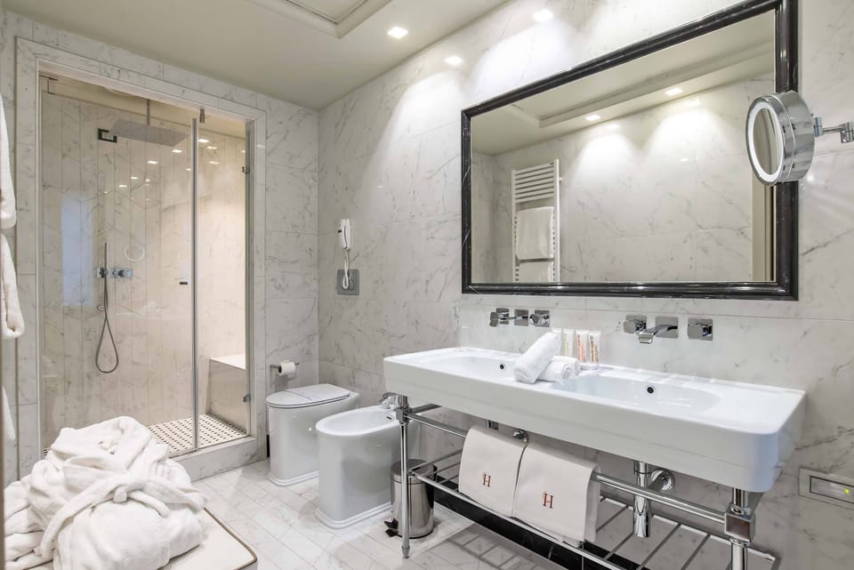 Designer toiletries, hair dryer, bathrobes, slippers