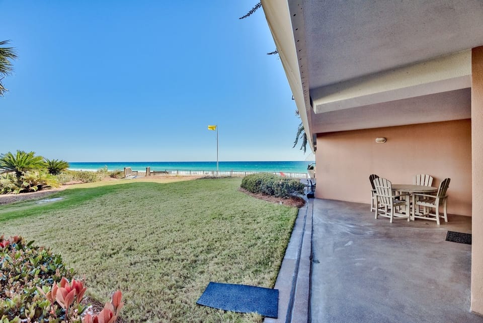 Patio and greenspace that leads to the beach walkover