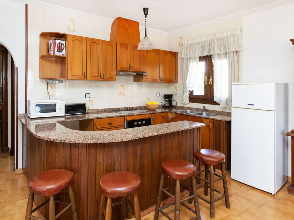 Countertop, Cabinetry, Furniture, Table, Refrigerator, Kitchen, Kitchen Appliance, Wood, Interior Design, Flooring