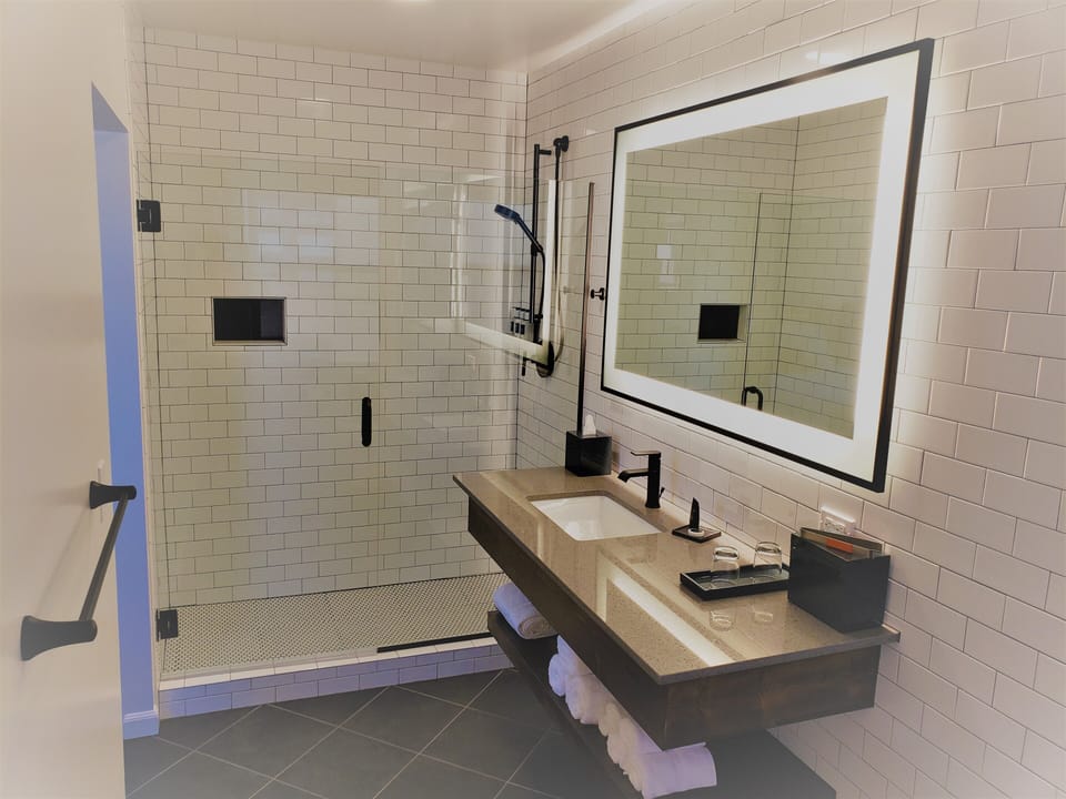 Shower, rainfall showerhead, designer toiletries, hair dryer