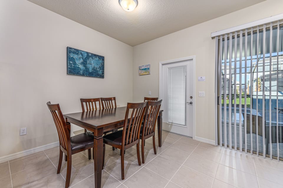 Classic dining table with sliding glass door access to patio