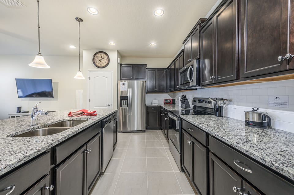 View 3 of beautiful modern style kitchen with microwave, stove, oven, and dishwasher