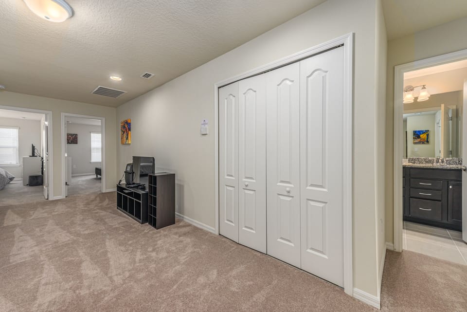 View 3 of comfortable upstairs lounge area with flat screen TV and closet